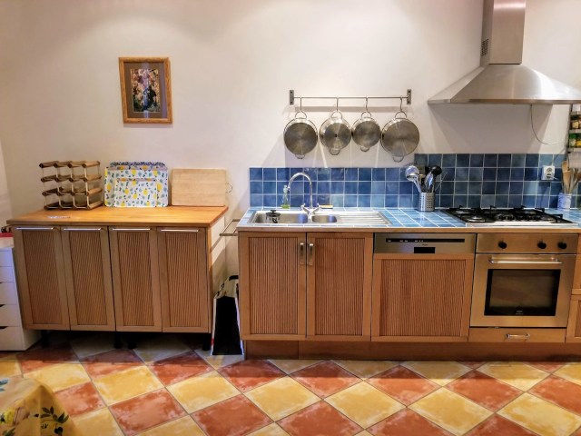 Kitchen cabinets, sink, and stove.